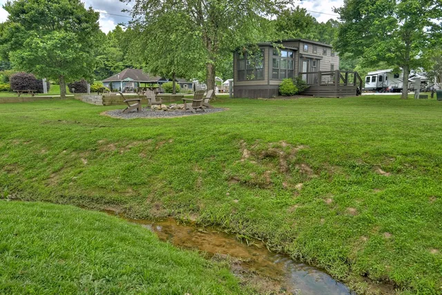 a view of a house with backyard and sitting area