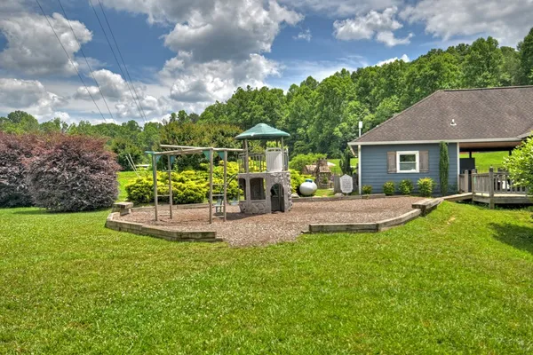 a view of a house with backyard and porch