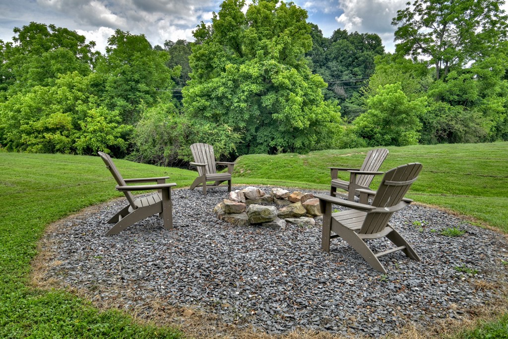 35 Mountain Meadows Circle Morganton, GA 30560 - Photo 6 of 41 a wooden bench sitting in the grass near a forest