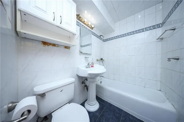 a bathroom with a sink a toilet and bathtub
