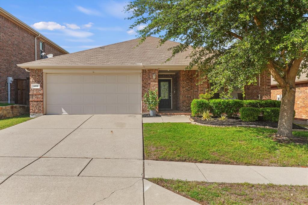 409 Harding Lane Lavon, TX 75166 - Photo 3 of 34 Brick-clad exterior with an attached garage and a covered entryway