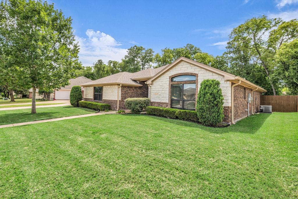 814 Springdale Circle Lorena, TX 76655 - Photo 6 of 37 Exterior facade featuring a combination of brick and stone masonry, an arched window, and a gabled roofline