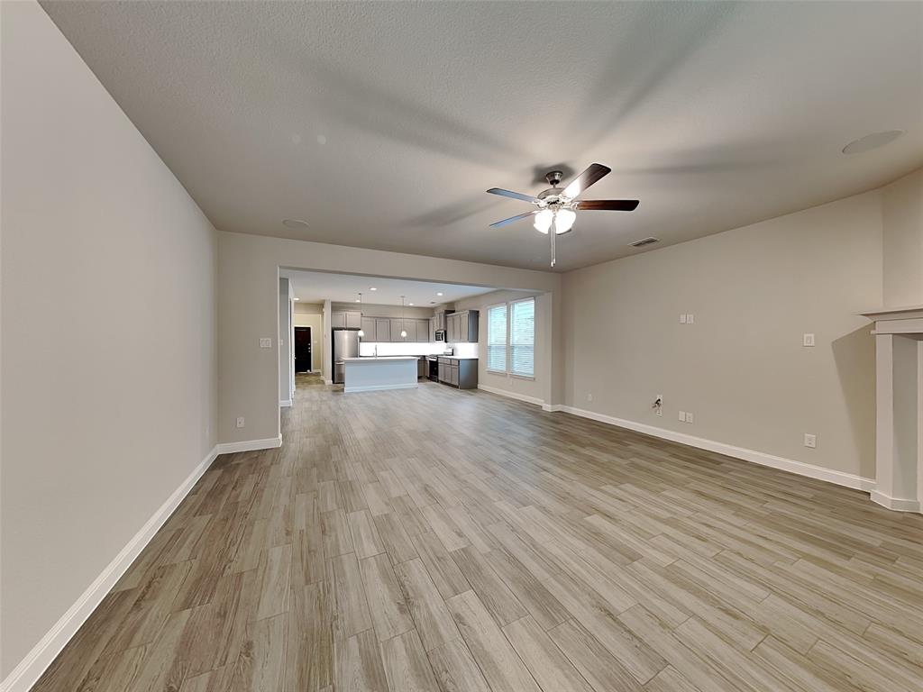 2344 Jack Rabbit Way Northlake, TX 76247 - Photo 2 of 17 a view of empty room with wooden floor and fan