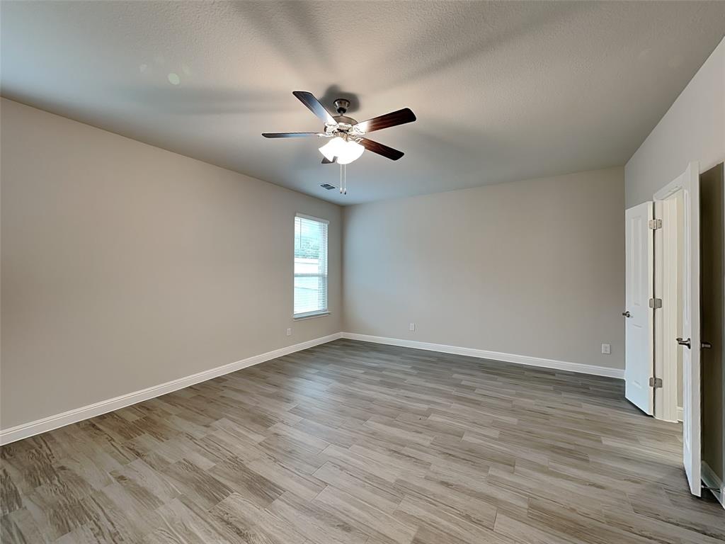 2344 Jack Rabbit Way Northlake, TX 76247 - Photo 6 of 17 a view of an empty room with window and wooden floor