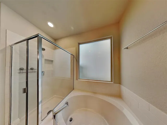 a bathroom with a tub and a shower