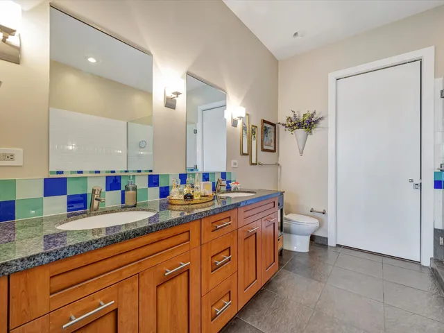 a spacious bathroom with a granite countertop sink mirror and toilet
