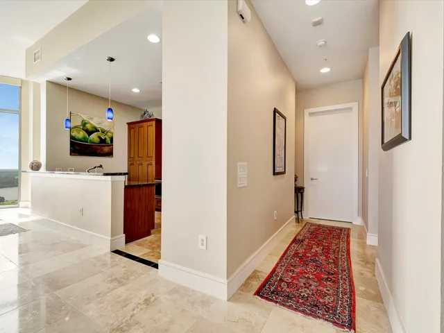 a view of a hallway with wooden floor and furniture