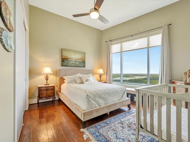 a bedroom with a bed and a large window