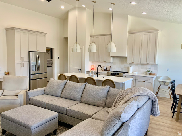 277 West 800 South Monroe, UT 84754 - Photo 4 of 46 Living room with light wood-style flooring and a high textured ceiling
