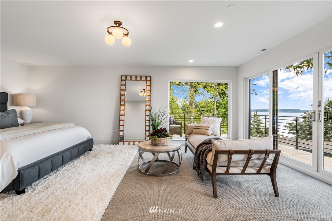 5616 Beach Drive Southwest Seattle, WA 98136 - Photo 15 of 40 a bedroom with a bed and a large window