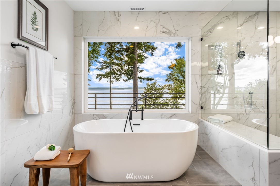 5616 Beach Drive Southwest Seattle, WA 98136 - Photo 18 of 40 a white bath tub sitting in a bathroom next to a window