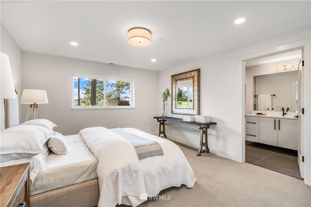 5616 Beach Drive Southwest Seattle, WA 98136 - Photo 24 of 40 a bedroom with a bed and a table