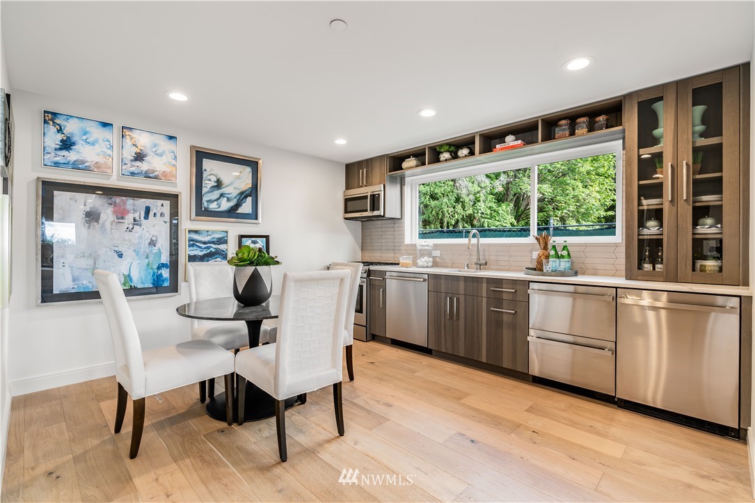 5616 Beach Drive Southwest Seattle, WA 98136 - Photo 25 of 40 a kitchen with a sink cabinets and wooden floor