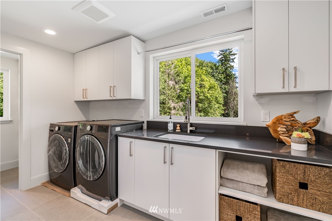 5616 Beach Drive Southwest Seattle, WA 98136 - Photo 28 of 40 a kitchen with a sink cabinets and window