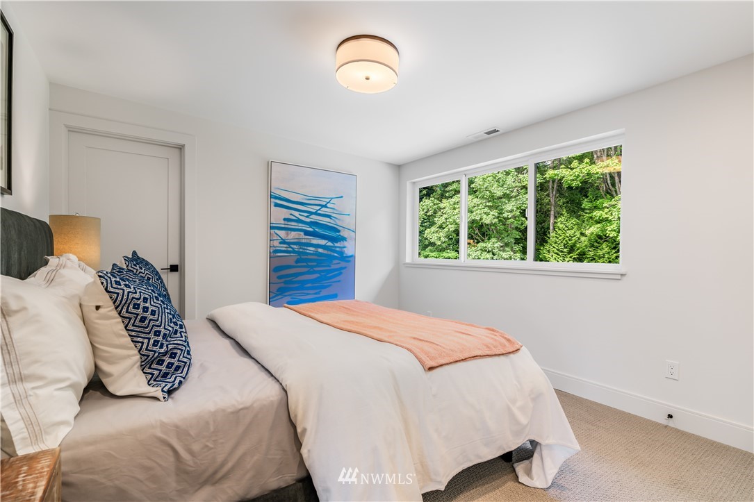 5616 Beach Drive Southwest Seattle, WA 98136 - Photo 29 of 40 a bedroom with a bed and a window