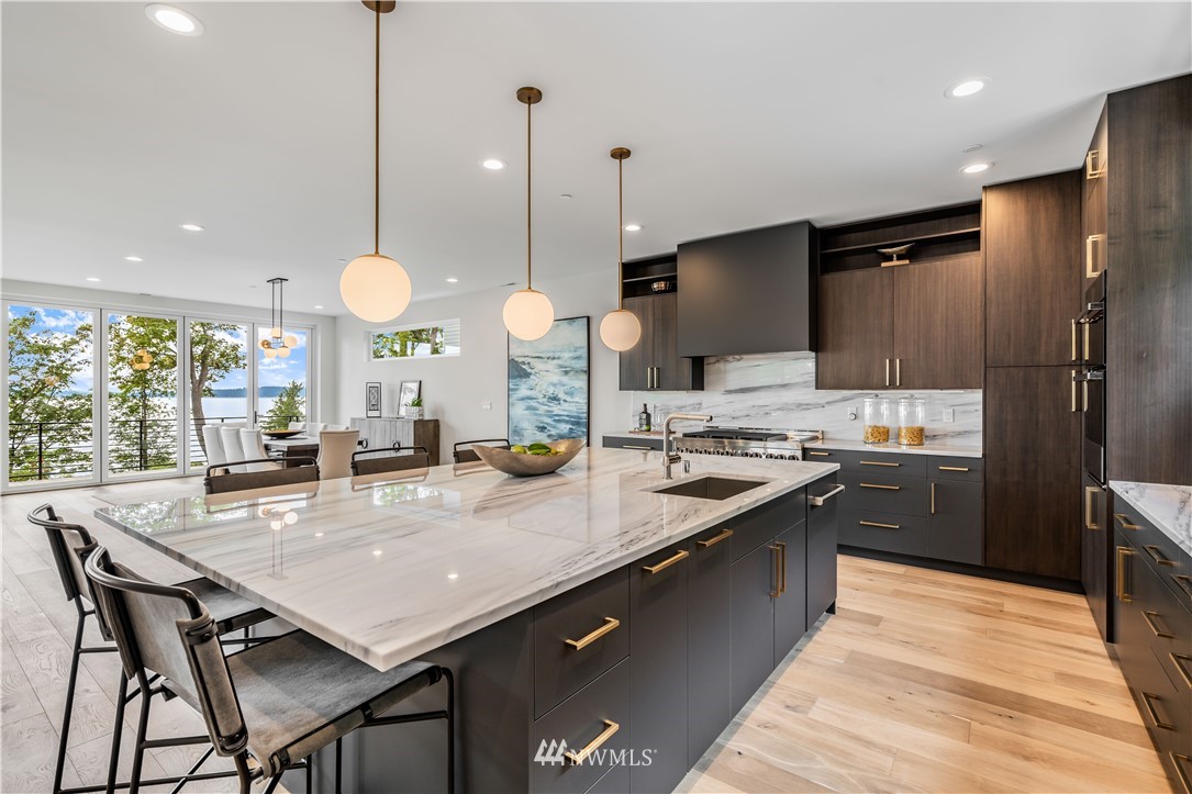 5616 Beach Drive Southwest Seattle, WA 98136 - Photo 9 of 40 a kitchen with stainless steel appliances granite countertop a sink a stove a refrigerator and wooden cabinets