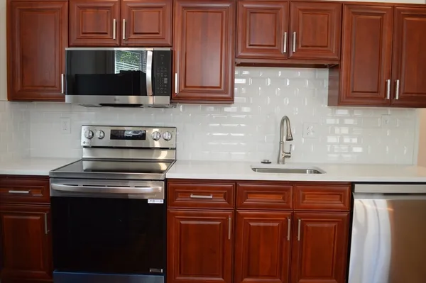 a kitchen with stainless steel appliances granite countertop a stove and a microwave