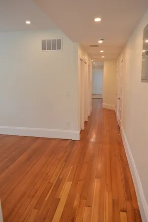 a view of a room with wooden floor and staircase