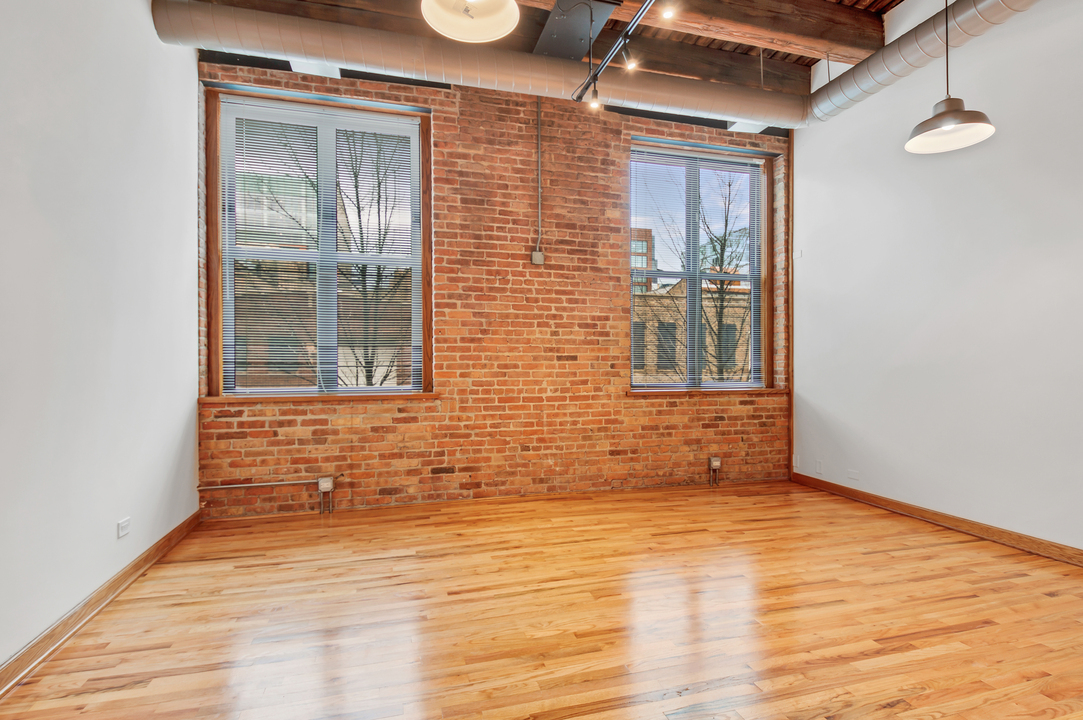 216 North May Street, Unit 103 Chicago, IL 60607 - Photo 13 of 21 a view of an empty room and wooden floor