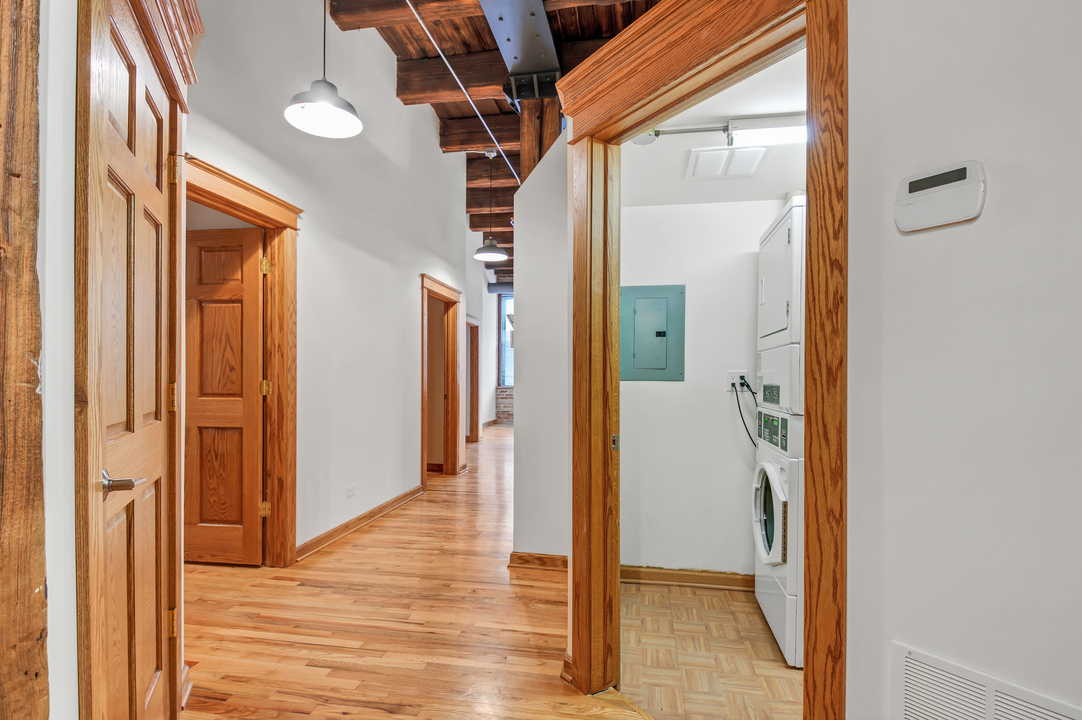 216 North May Street, Unit 103 Chicago, IL 60607 - Photo 7 of 21 a view of a hallway with wooden floor and staircase
