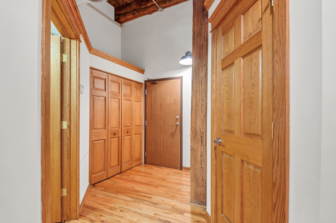 216 North May Street, Unit 103 Chicago, IL 60607 - Photo 8 of 21 a view of a hallway with wooden floor and entryway