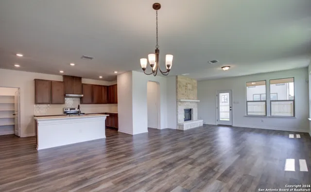 a view of a kitchen with stove and wooden floor