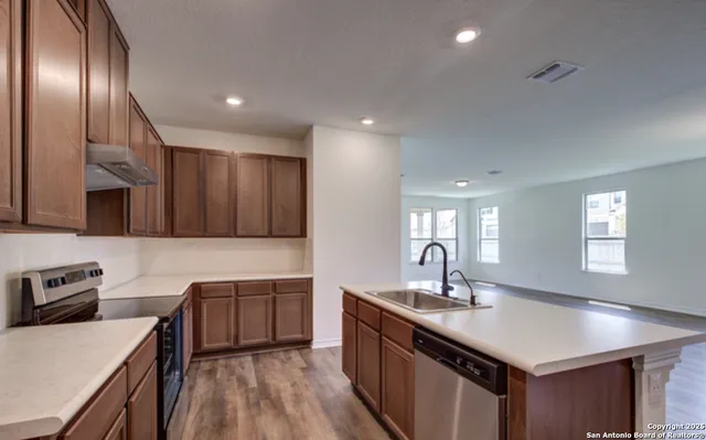 a kitchen with a sink and a refrigerator