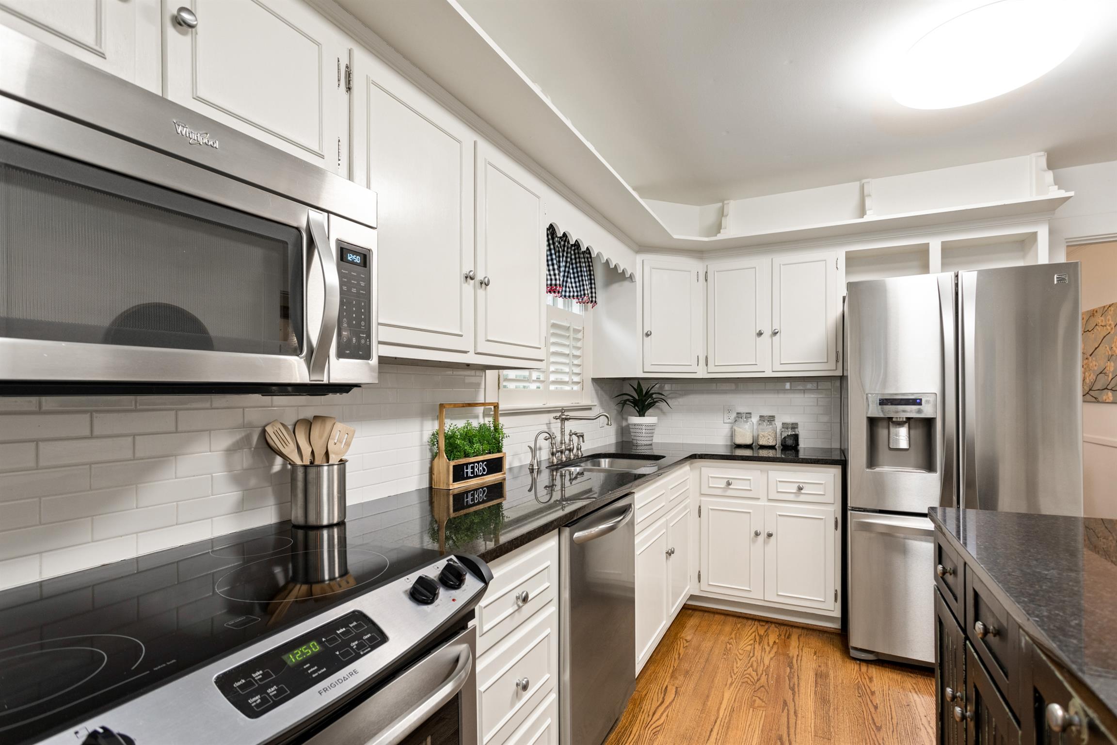 921 Fair Street Franklin, TN 37064 - Photo 14 of 30 a kitchen with stainless steel appliances a stove microwave and sink