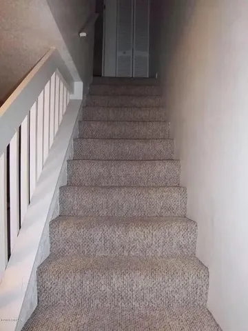 a view of staircase with white walls