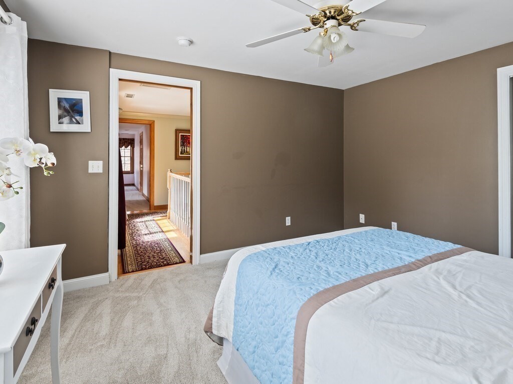9 Santom Street Auburn, MA 01501 - Photo 27 of 42 a bedroom with a bed and a chandelier