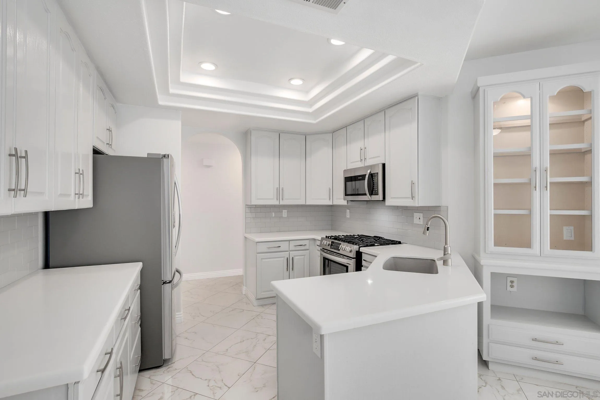 3355 Genoa Way, Unit 134 Oceanside, CA 92056 - Photo 11 of 32 a kitchen with a sink a stove and refrigerator