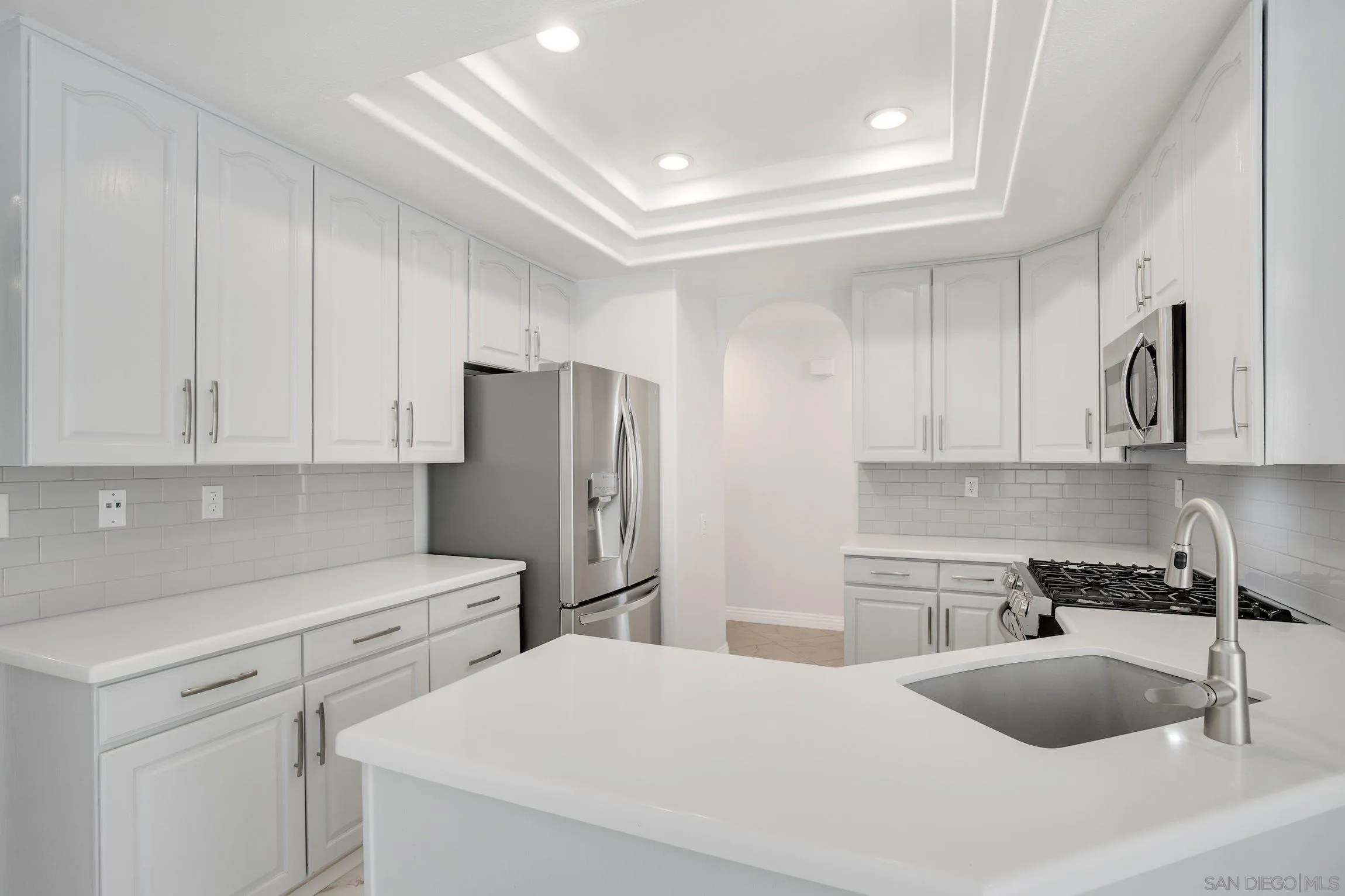 3355 Genoa Way, Unit 134 Oceanside, CA 92056 - Photo 12 of 32 a kitchen with stainless steel appliances a refrigerator sink and cabinets