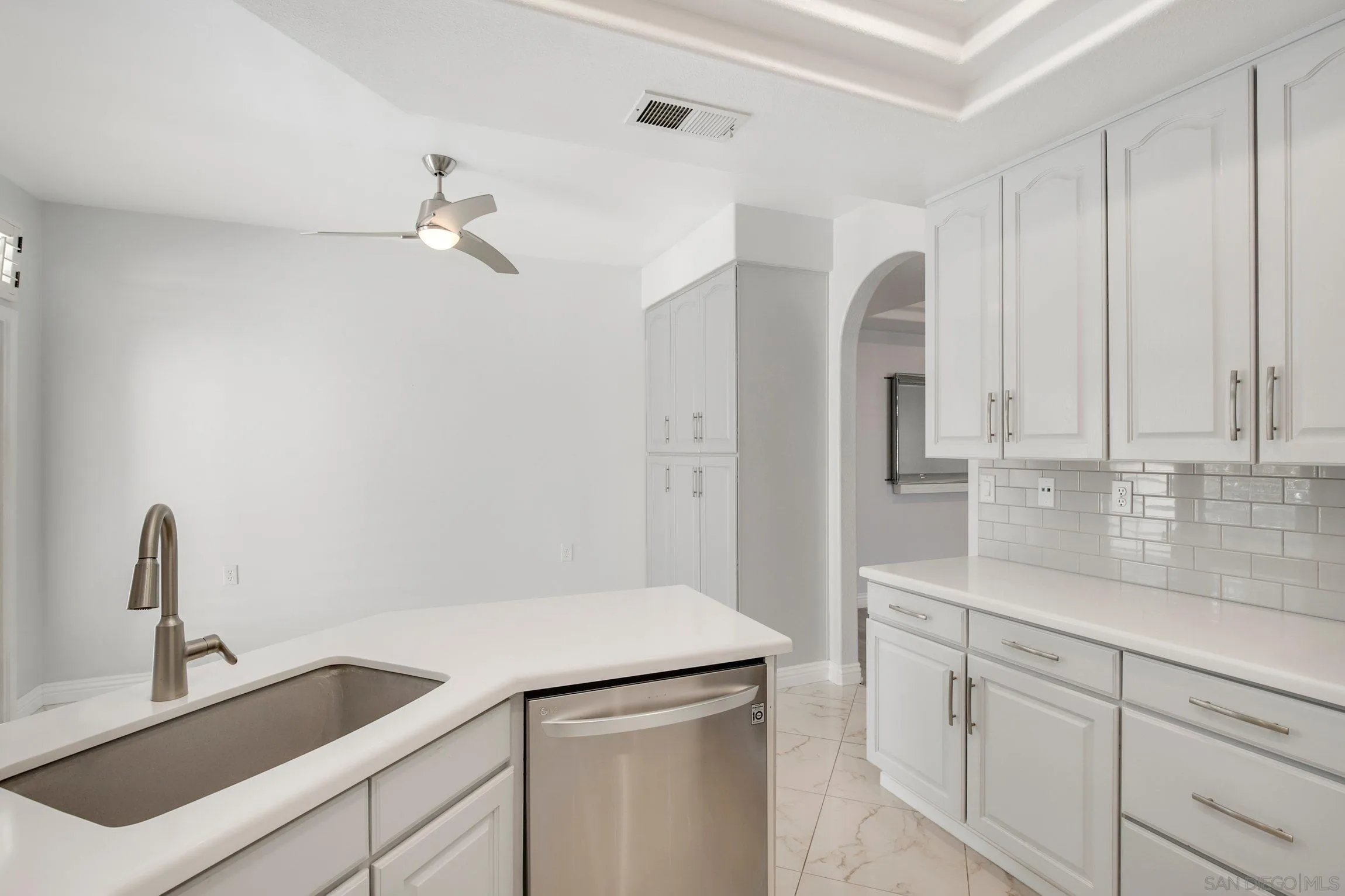 3355 Genoa Way, Unit 134 Oceanside, CA 92056 - Photo 14 of 32 a kitchen with a sink and cabinets