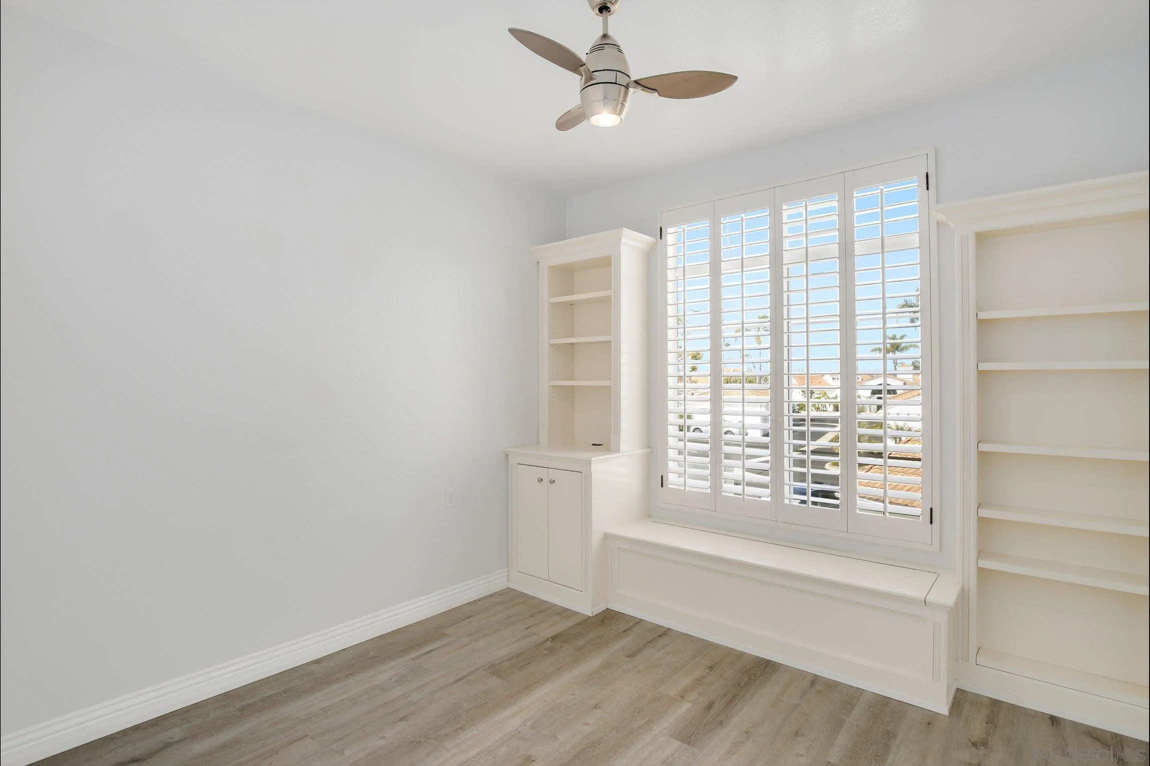 3355 Genoa Way, Unit 134 Oceanside, CA 92056 - Photo 16 of 32 a view of an empty room with a window and wooden floor