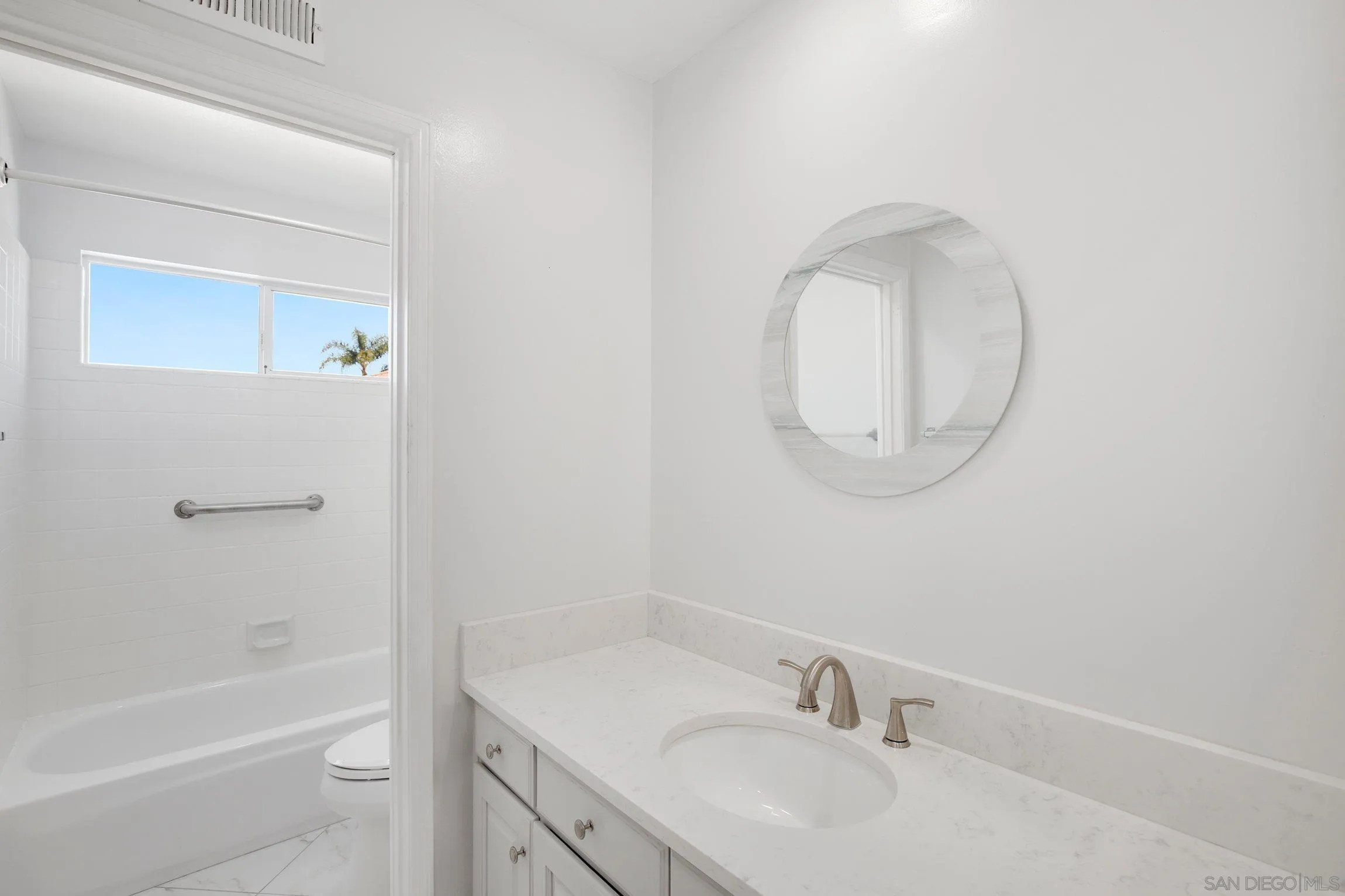 3355 Genoa Way, Unit 134 Oceanside, CA 92056 - Photo 17 of 32 a bathroom with a sink a toilet and a mirror