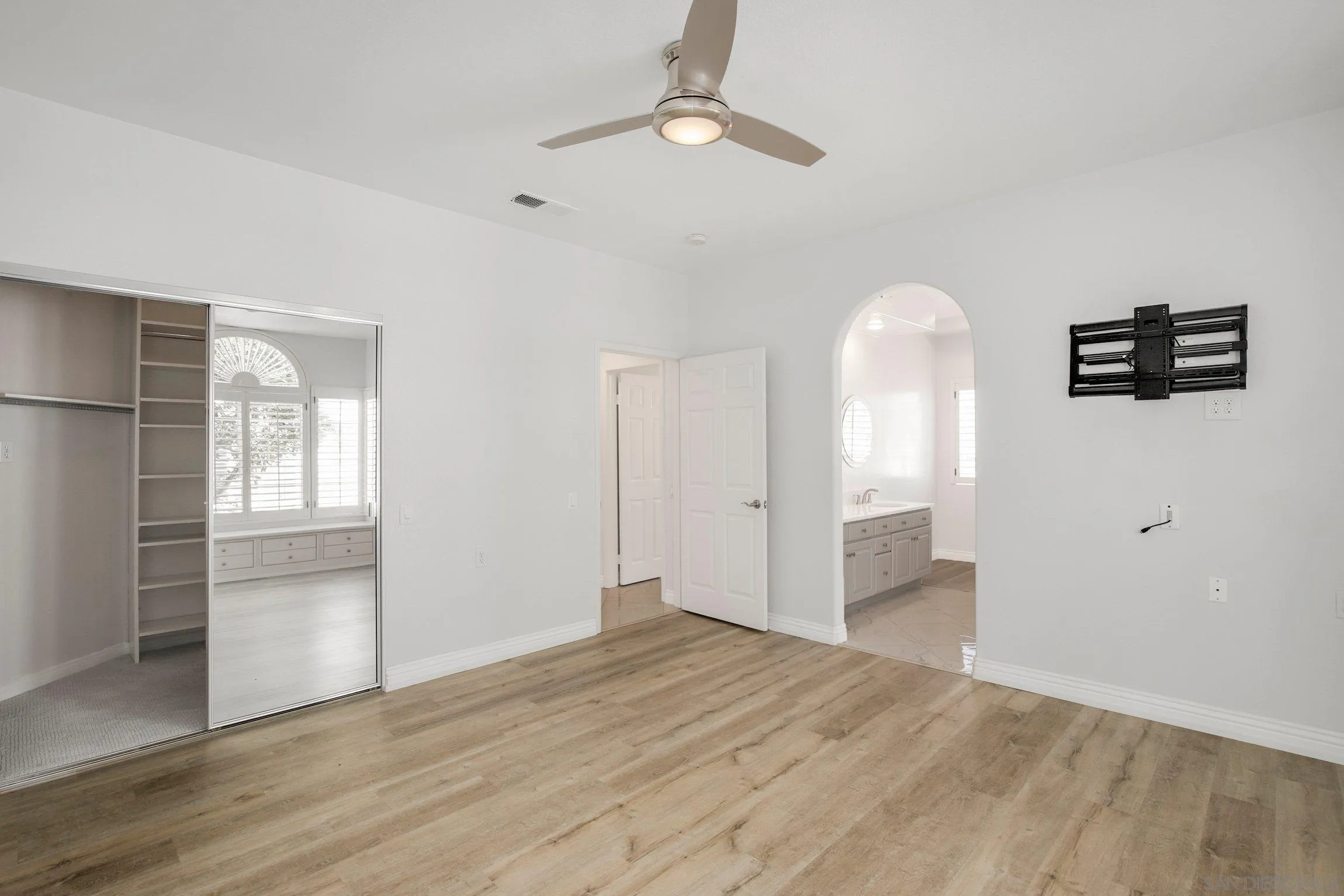 3355 Genoa Way, Unit 134 Oceanside, CA 92056 - Photo 20 of 32 an empty room with wooden floor cabinet and windows