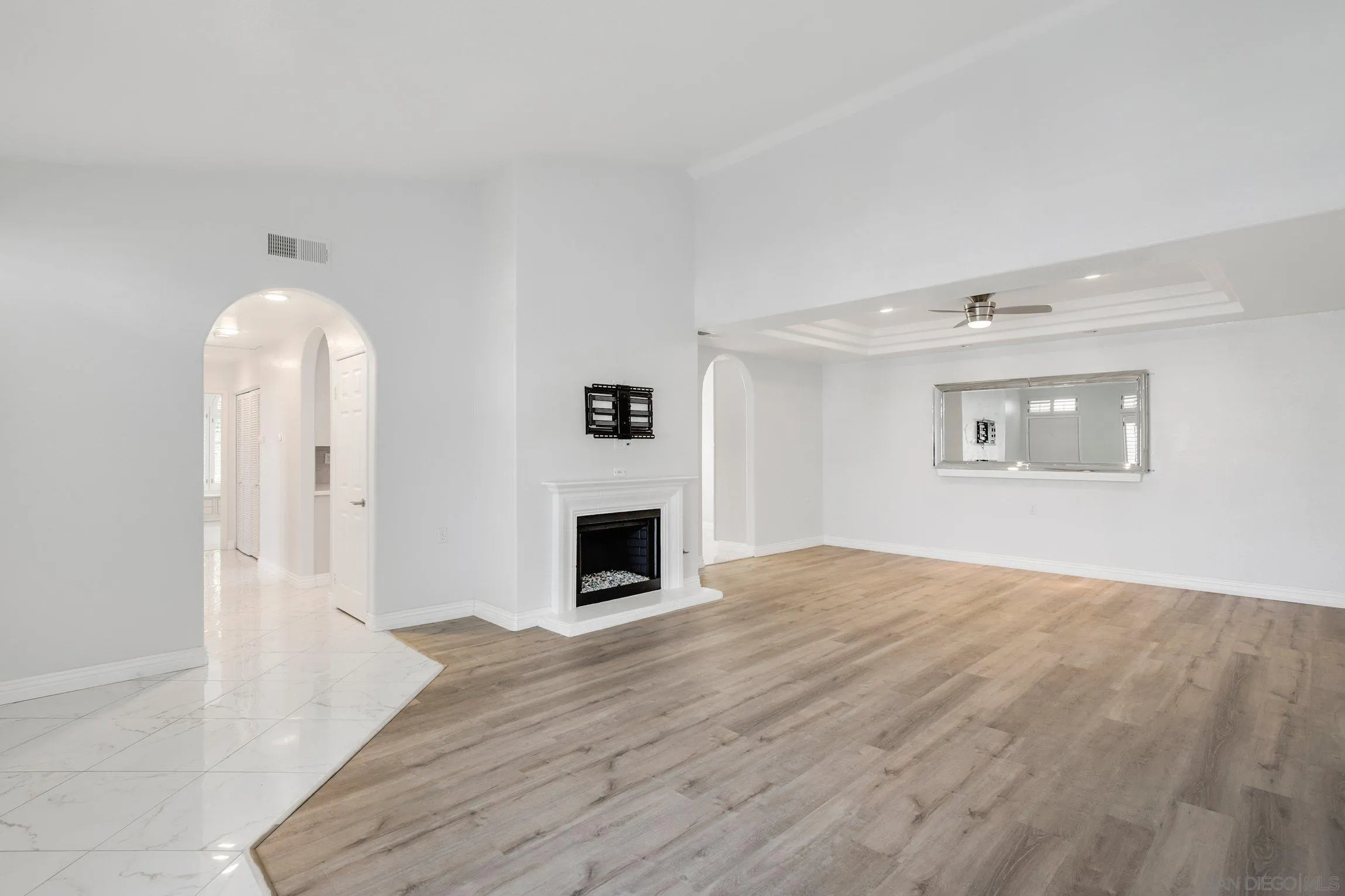 3355 Genoa Way, Unit 134 Oceanside, CA 92056 - Photo 5 of 32 a view of empty room with wooden floor and fireplace