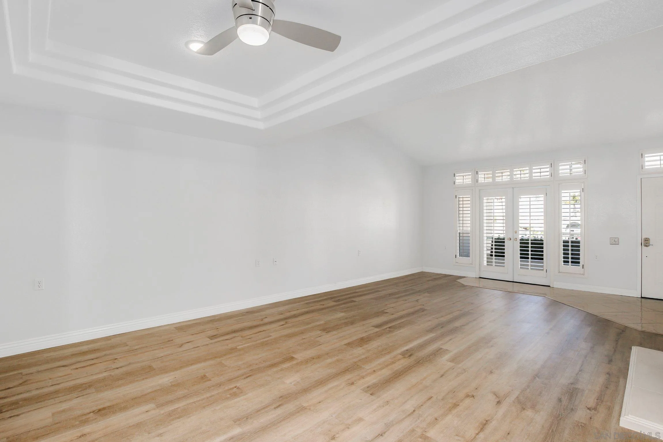3355 Genoa Way, Unit 134 Oceanside, CA 92056 - Photo 7 of 32 a view of an empty room with wooden floor and a window