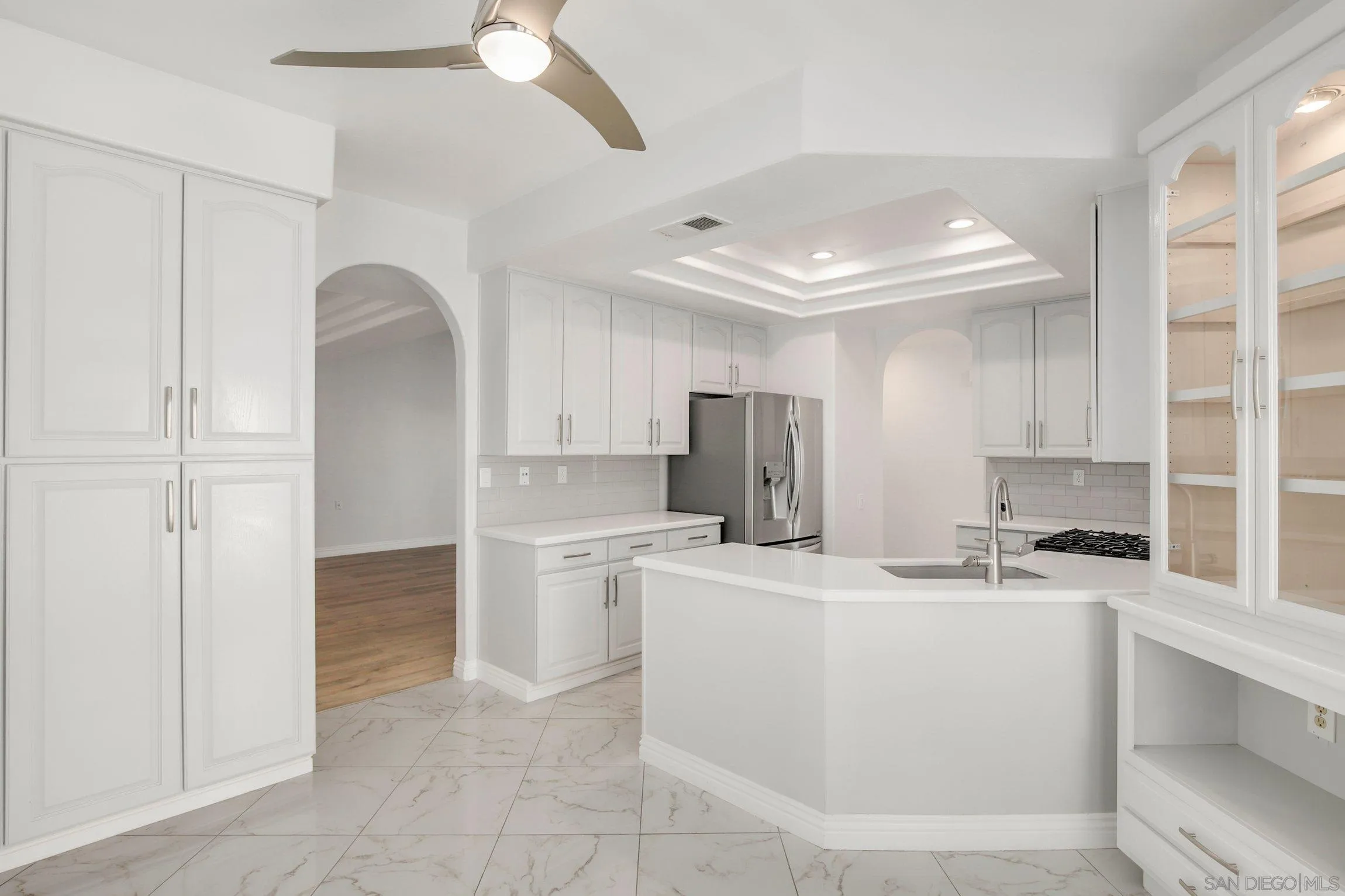 3355 Genoa Way, Unit 134 Oceanside, CA 92056 - Photo 9 of 32 a kitchen with stainless steel appliances a refrigerator sink and cabinets