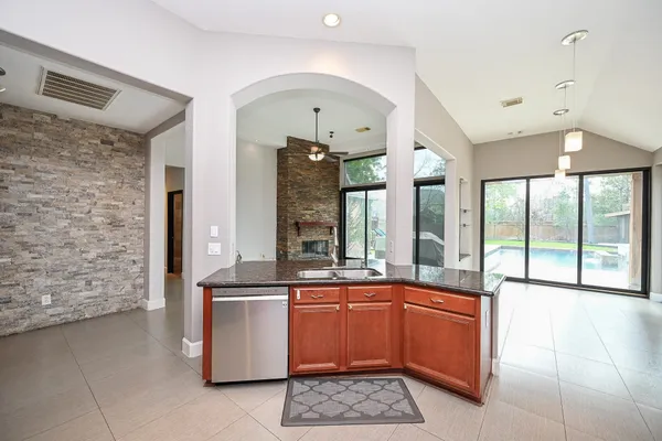 a front view of a house with swimming pool having outdoor seating