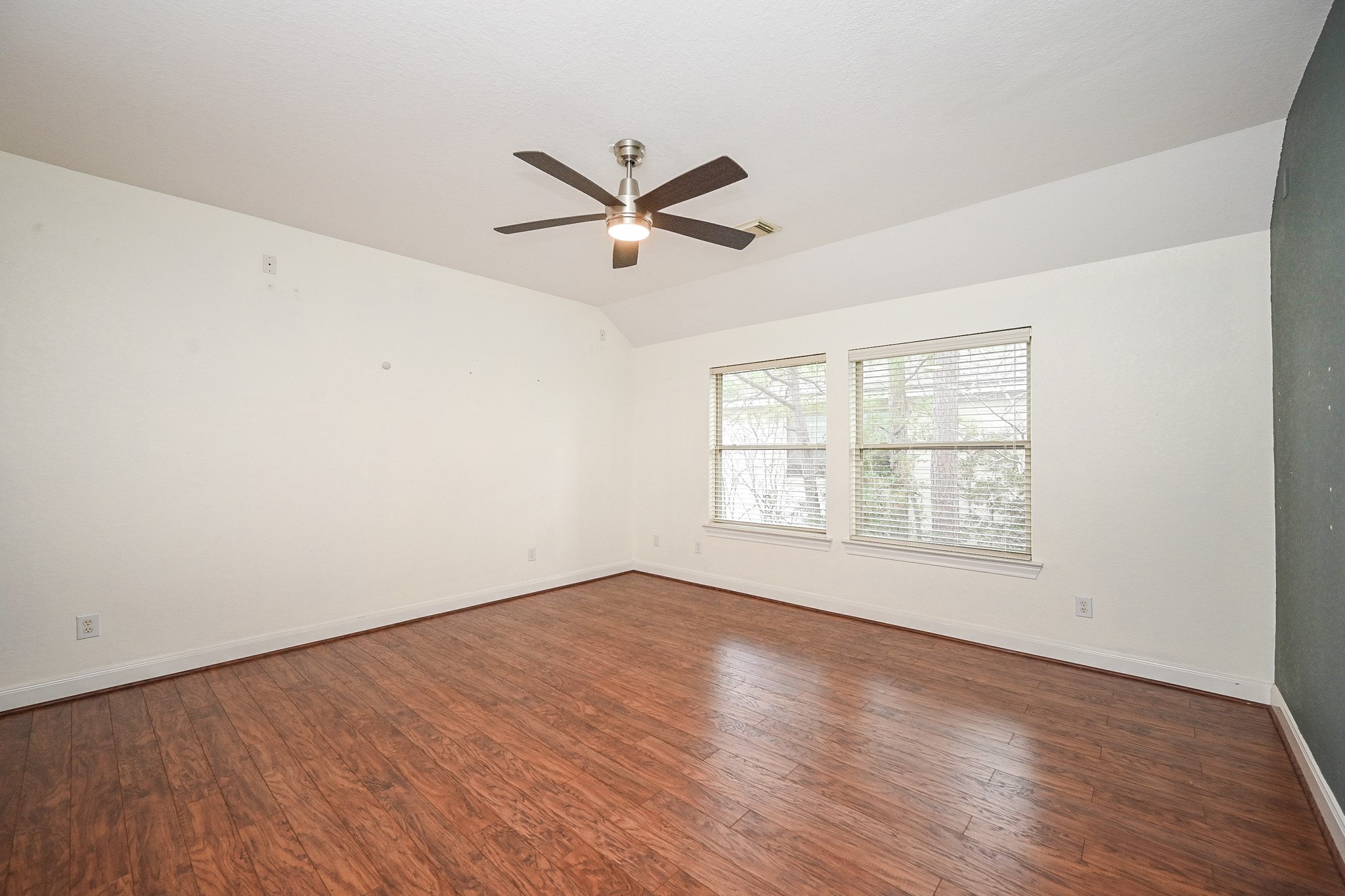 146 Rocky Point Drive Spring, TX 77389 - Photo 27 of 37 an empty room with wooden floor fan and windows