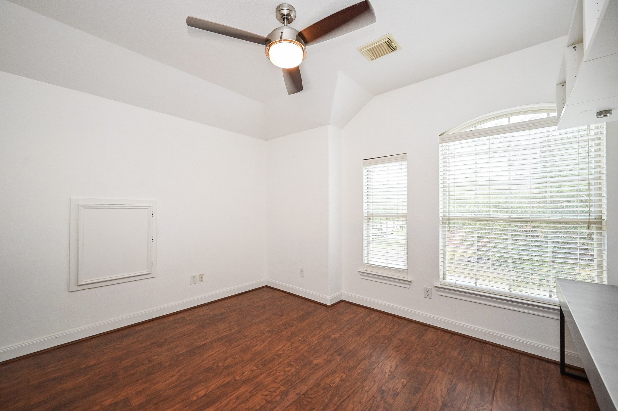 146 Rocky Point Drive Spring, TX 77389 - Photo 28 of 37 an empty room with wooden floor ceiling fan and windows