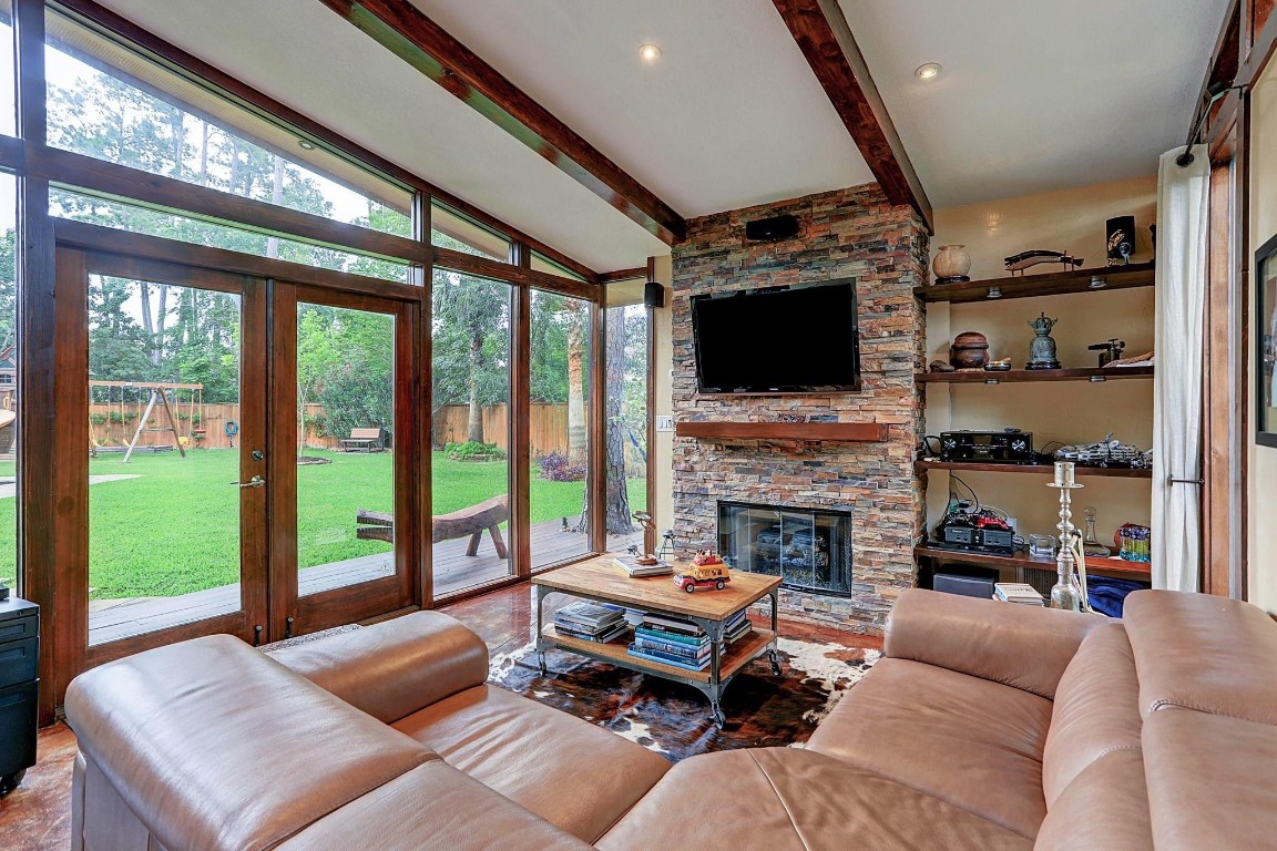 146 Rocky Point Drive Spring, TX 77389 - Photo 34 of 37 a living room with furniture a fireplace and a flat screen tv