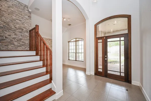 a view of an empty room window and wooden floor
