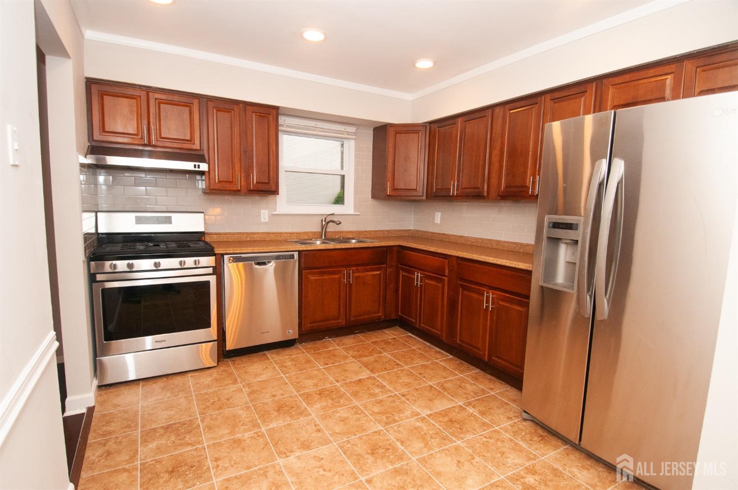 6806 Hana Road Edison, NJ 08817 - Photo 7 of 28 a kitchen with stainless steel appliances granite countertop a stove a refrigerator and a sink