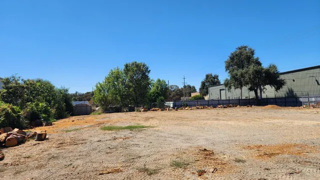 a view of a yard with snow on the road