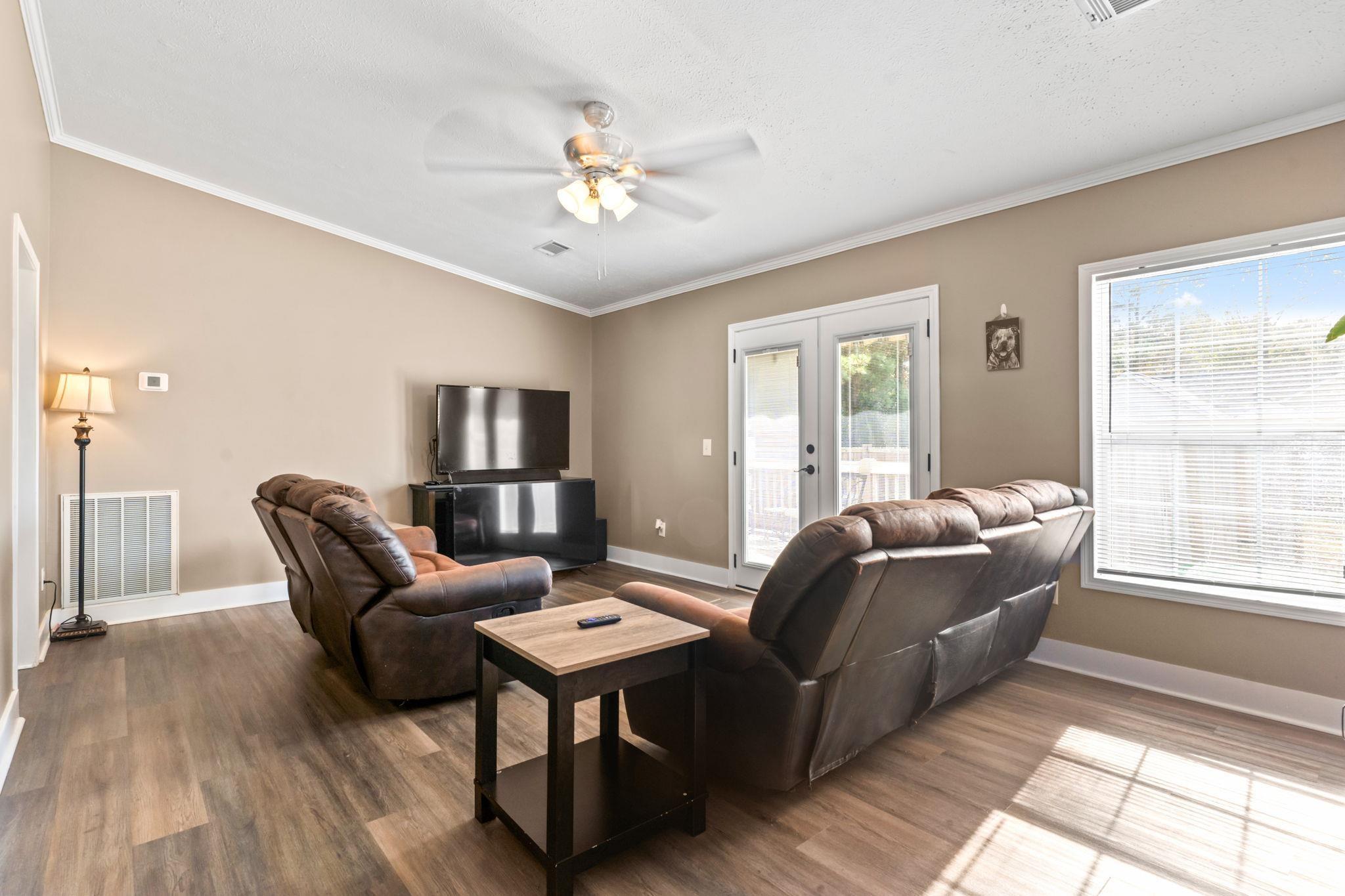 2977 Silverleaf Circle Loris, SC 29569 - Photo 13 of 36 Living area with crown molding, a ceiling fan, dark wood finished floors, and french doors