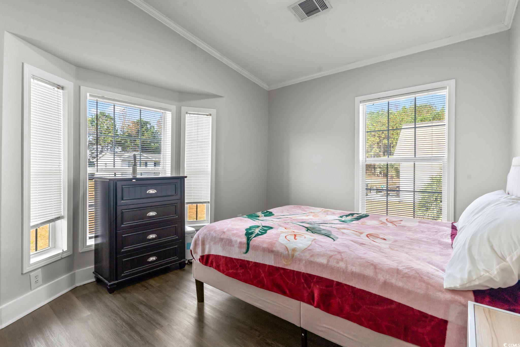 2977 Silverleaf Circle Loris, SC 29569 - Photo 15 of 36 Bedroom with crown molding, lofted ceiling, and dark wood finished floors