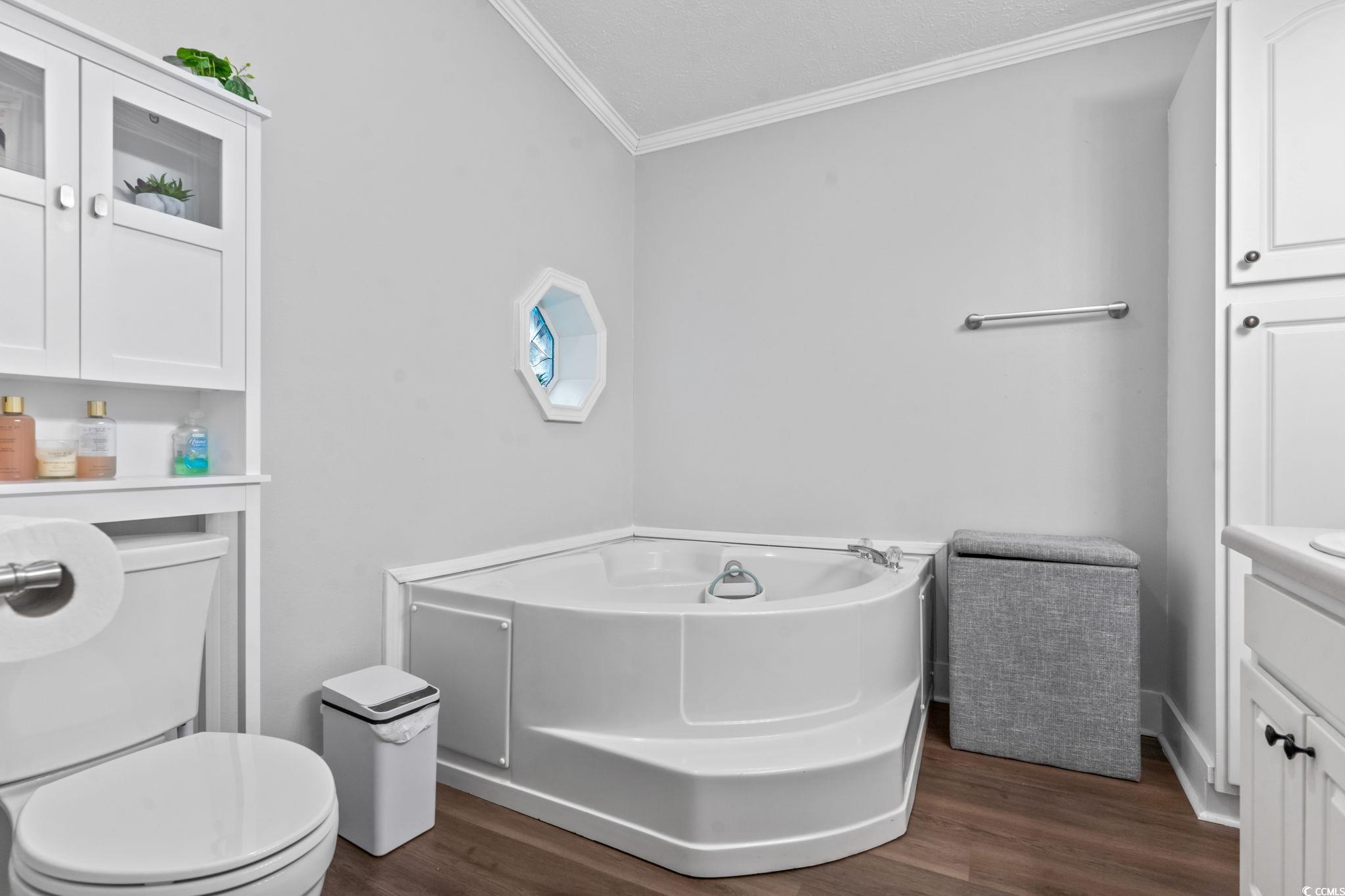 2977 Silverleaf Circle Loris, SC 29569 - Photo 23 of 36 Bathroom with crown molding, independent washer and dryer, dark wood finished floors, double vanity, and shower / bath combo