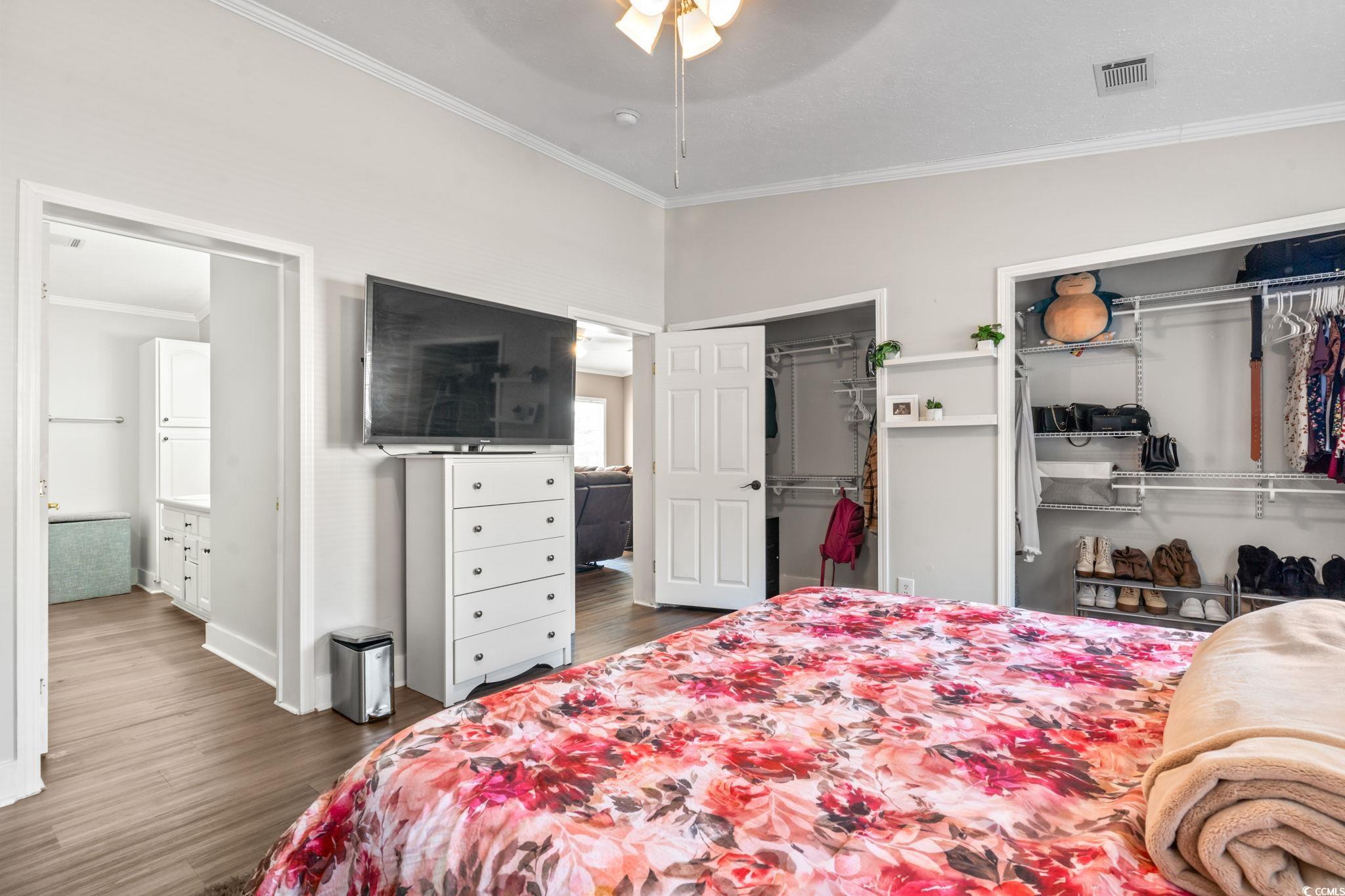 2977 Silverleaf Circle Loris, SC 29569 - Photo 26 of 36 Bedroom featuring crown molding, ceiling fan, and wood finished floors
